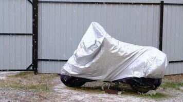 Motorcycle storage under an awning in winter outdoor. Protective awning, under the snow video