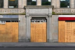 New York City, New York - June 11, 2020 -  Store closed during the COVID-19 pandemic, with boarded up windows to protect against looting as a result of anti-police brutality protests. photo