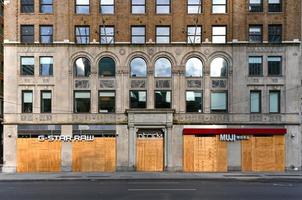 New York City, New York - June 11, 2020 -  Store closed during the COVID-19 pandemic, with boarded up windows to protect against looting as a result of anti-police brutality protests. photo