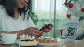 Woman use smartphone to scan QR code to pay in cafe restaurant with a digital payment without cash. Choose menu and order accumulate discount. E wallet, technology, pay online, credit card, bank app video