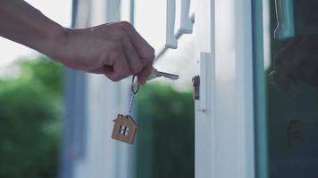 landheer ontgrendelt de huis sleutel voor nieuw huis. voorbereiding en in beweging voor een nieuw residentie. concept kopen nieuw huis. video