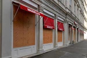 New York City, New York - June 11, 2020 -  Store closed during the COVID-19 pandemic, with boarded up windows to protect against looting as a result of anti-police brutality protests. photo