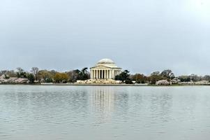 Cherry blossoms at the Tidal Basin and Jefferson Memorial during spring in Washington, DC. photo