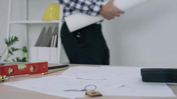 Engineer checks the drawing again before construction. A construction contractor is reading a house plan. The engineer went to the information desk to check. video