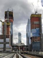 View of the Hudson Yards train depot and building development seen from the High Line, an elevated green urban park running along old rail track lines in New York City. photo