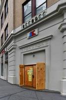 New York City, New York - June 11, 2020 -  Store closed during the COVID-19 pandemic, with boarded up windows to protect against looting as a result of anti-police brutality protests. photo