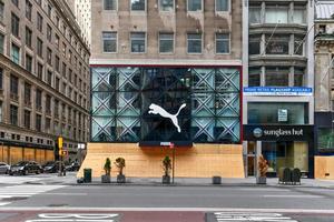 New York City, New York - June 11, 2020 -  Store closed during the COVID-19 pandemic, with boarded up windows to protect against looting as a result of anti-police brutality protests. photo