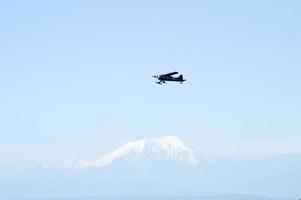 Plane flying past the mountains surrounding Talkeetna, Alaska photo