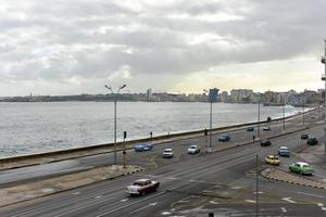 The Malecon in Havana. It is a broad esplanade, roadway and seawall which stretches for 8 km along the coast in Havana, Cuba. photo