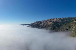 Ocean fog rolling in onto Highway 1 and Big Sur, California, USA photo