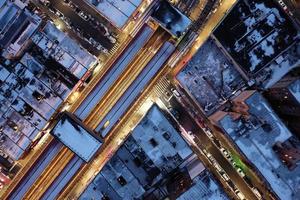 Aerial top-down view of elevated subway tracks in New York City on a winter day.