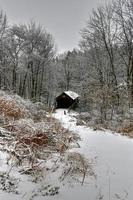 herrería puente cubierto durante el invierno en new hampshire. Construido en 1882, es un histórico puente cubierto que cruza Mill Brook cerca de Town House Road en Cornualles, New Hampshire, Estados Unidos. foto