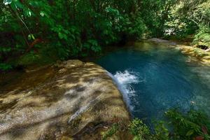 El Nicho Waterfalls in Cuba. El Nicho is located inside the Gran Parque Natural Topes de Collantes, a forested park that extends across the Sierra Escambray mountain range in central Cuba. photo