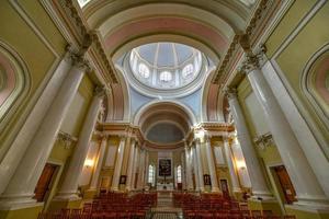 St Petersburg, Russia - July 3, 2018 -  The Catholic Church of St Catherine with monumental arched portal on self-supporting columns, located in Nevsky Prospekt, St Petersburg, Russia. photo