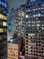 New York cityscape at night up close of towering building. photo