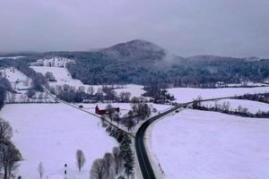 Rural farmhouse and barn in Brownsville, Vermont during the winter. photo