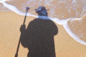 Photographer's shadow on the seashore. photo