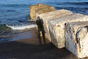 Photographer's shadow on the seashore. photo