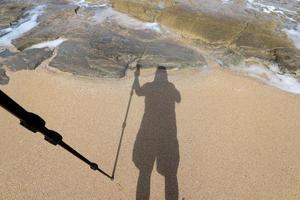 Photographer's shadow on the seashore. photo