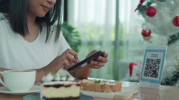 Woman use smartphone to scan QR code to pay in cafe restaurant with a digital payment without cash. Choose menu and order accumulate discount. E wallet, technology, pay online, credit card, bank app video