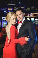 Young, beautiful and well dressed couple in casino photo