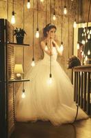Young happy bride wearing beautiful lush dress photo