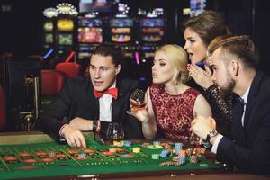 Young and rich people playing roulette in the casino photo