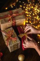 Female hands and christmas gifts with a lot of glowing lights photo