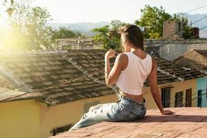 Woman sitting on the roof of old house photo