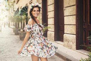 Happy woman in beautiful dress on the street photo