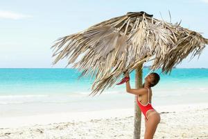 Sexy woman on the white sand beach photo