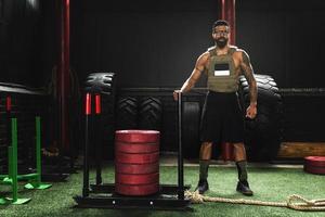 Sportsman wearing weight vest during his workout photo