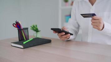 woman uses a credit card to pay for goods after shopping online through a socially marketed merchant's website. The buyer pays for water, electricity and telephone bills via computer by debit card. video