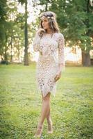 Beautiful woman wearing lace dress and circlet of flowers photo