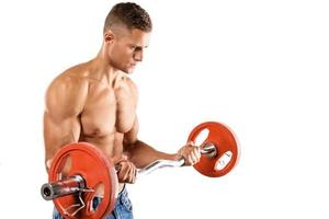 Young muscular man doing bicep barbell curl exercise photo