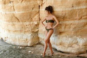 Young and beautiful woman beside a sand cliffs photo