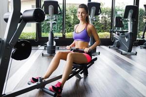 Woman doing exercise for her back - Seated cable row photo