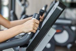 Fitness workout on stationary bike in gym photo