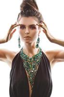 Sexy woman wearing big beautiful necklace with a lot of gems photo