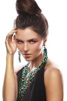 Sexy woman wearing big beautiful necklace with a lot of gems photo