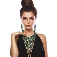 Sexy woman wearing big beautiful necklace with a lot of gems photo