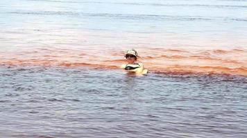 Lady laying down on a sand bar in the Rio Negro river in Amazonas, Brazil video