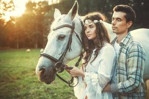 Young happy couple and beautiful white horse photo