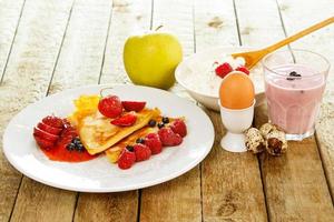 Healthy breakfast. Different food on wooden table. photo