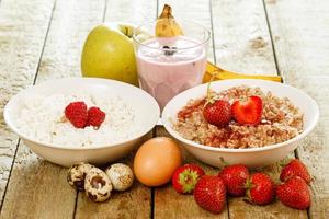 Healthy breakfast. Different food on wooden table. photo