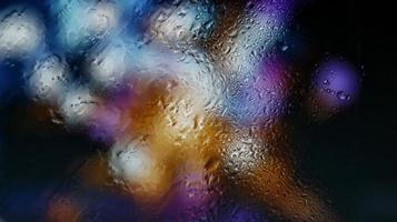 Purple Neon Blurred Lights Through Glass Window With Raindrops On It in Karachi Pakistan 2022 photo