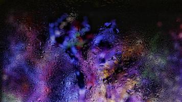 Purple Neon Blurred Lights Through Glass Window With Raindrops On It in Karachi Pakistan 2022 photo