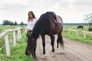 Young woman rider and her beautiful horse photo