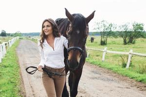 Young woman rider and her beautiful horse photo