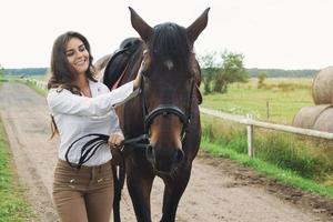 Young woman rider and her beautiful horse photo